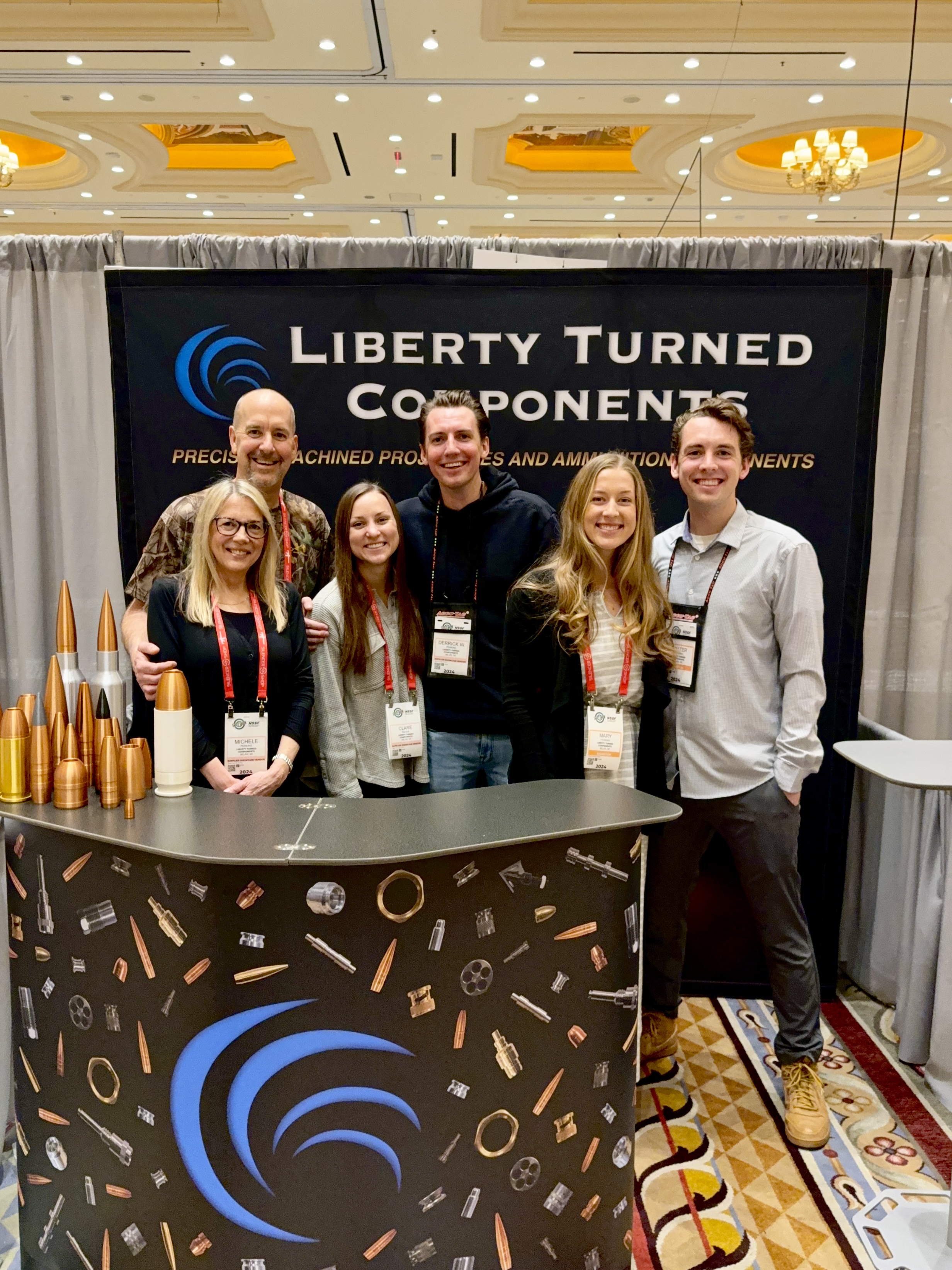 The Perkins family at the Liberty Turned Components trade-show display
